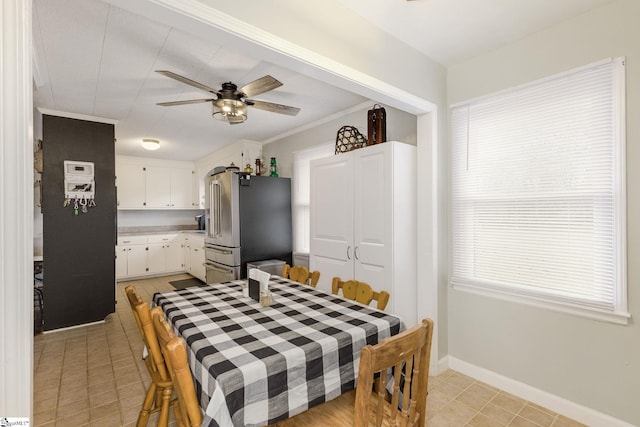 dining room with light tile patterned floors, baseboards, and a ceiling fan