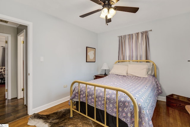 bedroom featuring wood finished floors, baseboards, and ceiling fan