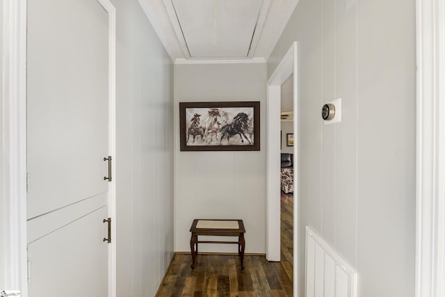 corridor with visible vents, attic access, dark wood-style floors, and ornamental molding