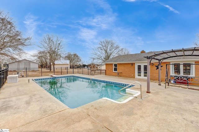 view of pool with a fenced in pool, fence, french doors, a pergola, and a patio