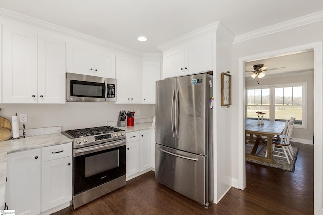 kitchen with white cabinetry, stainless steel appliances, crown molding, and dark wood-type flooring