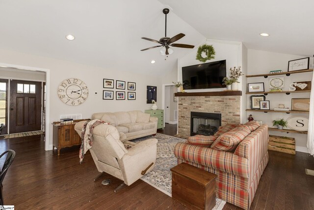 living room with a fireplace, wood finished floors, a ceiling fan, and vaulted ceiling