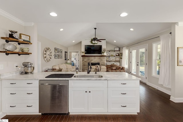 kitchen with light stone counters, a ceiling fan, a sink, stainless steel dishwasher, and open floor plan