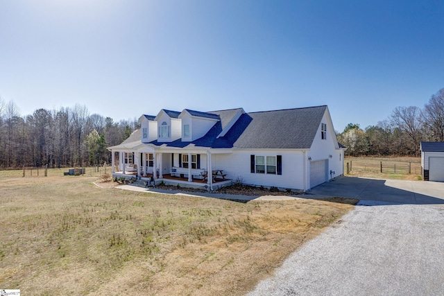 cape cod home with concrete driveway, fence, covered porch, and a front lawn