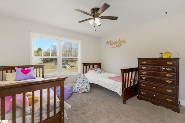 bedroom featuring light carpet and a ceiling fan