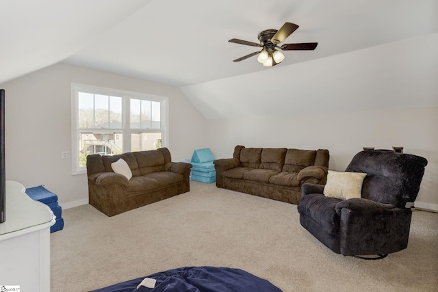 carpeted living room featuring baseboards, ceiling fan, and vaulted ceiling