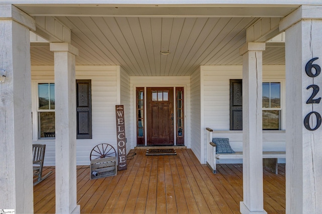 view of exterior entry with covered porch