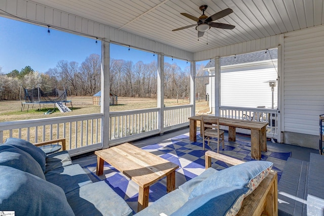 sunroom featuring ceiling fan