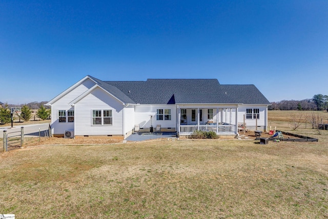 rear view of house featuring a shingled roof, fence, a porch, a yard, and crawl space