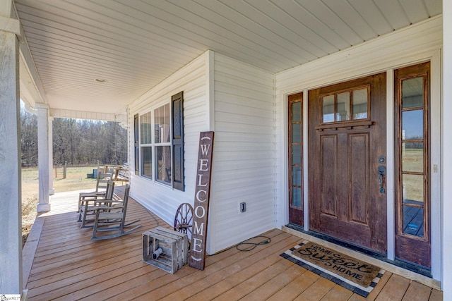 view of exterior entry with a porch