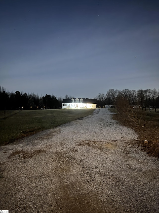 view of street featuring gravel driveway