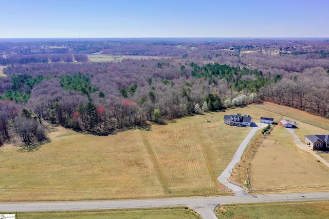 bird's eye view featuring a rural view and a wooded view