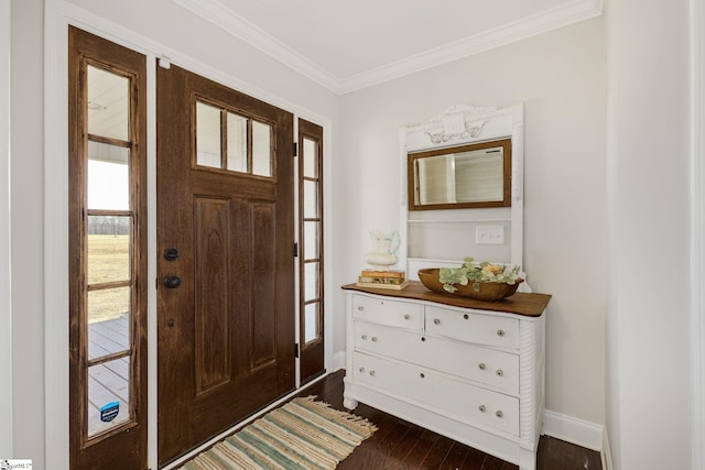 foyer featuring dark wood finished floors, baseboards, and ornamental molding