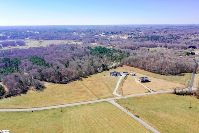 birds eye view of property featuring a rural view and a forest view