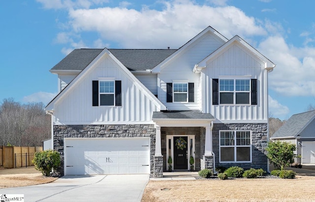 view of front of home with stone siding, board and batten siding, concrete driveway, and a garage