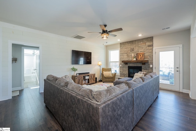 living room featuring visible vents, dark wood finished floors, and a ceiling fan