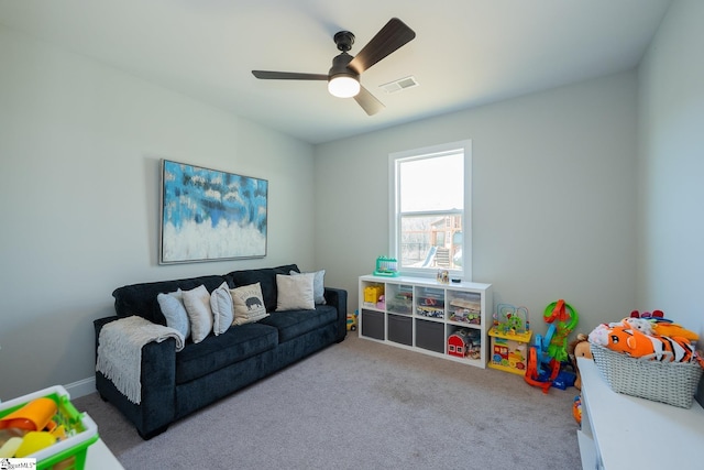 playroom featuring visible vents, carpet floors, baseboards, and a ceiling fan