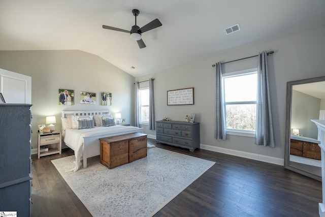 bedroom featuring visible vents, baseboards, lofted ceiling, dark wood-style floors, and a ceiling fan