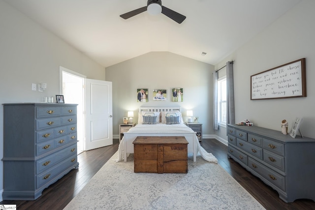 bedroom with visible vents, a ceiling fan, dark wood finished floors, baseboards, and vaulted ceiling