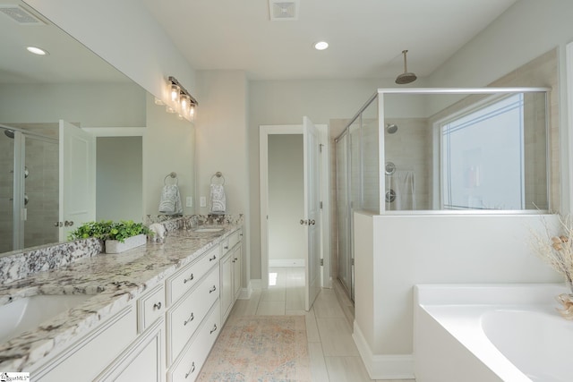 full bathroom featuring double vanity, visible vents, a stall shower, and a sink