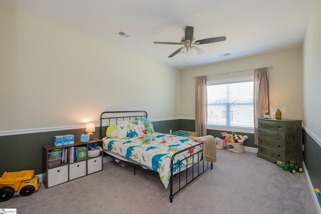 bedroom with visible vents, ceiling fan, and carpet