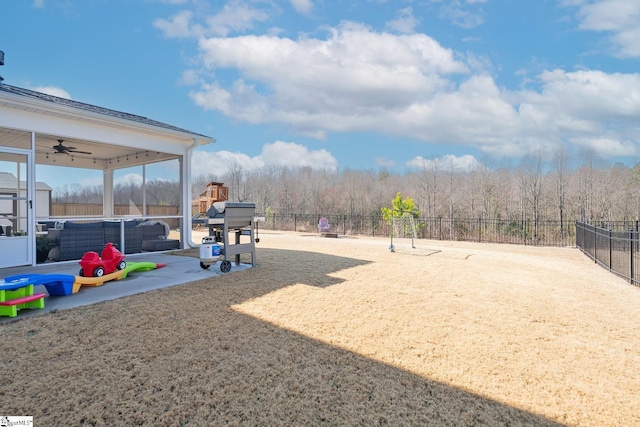 view of yard featuring a ceiling fan, a patio, and a fenced backyard