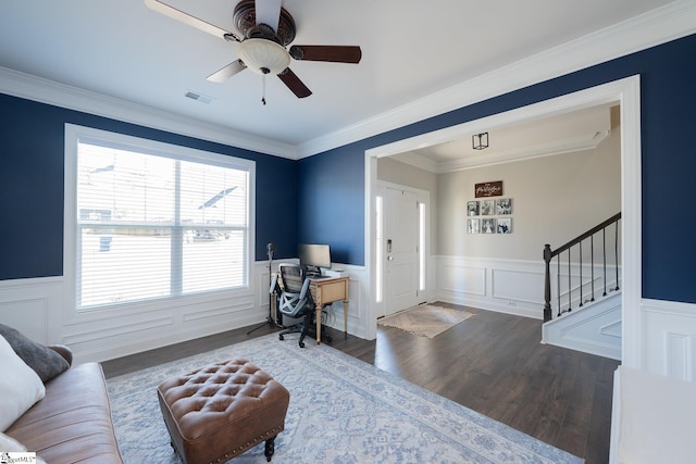 office space with a wainscoted wall, ornamental molding, ceiling fan, and wood finished floors