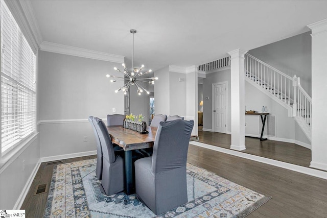 dining room with visible vents, ornamental molding, wood finished floors, baseboards, and stairs