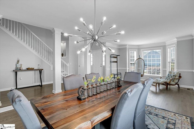 dining space featuring ornamental molding, wood finished floors, an inviting chandelier, baseboards, and stairs