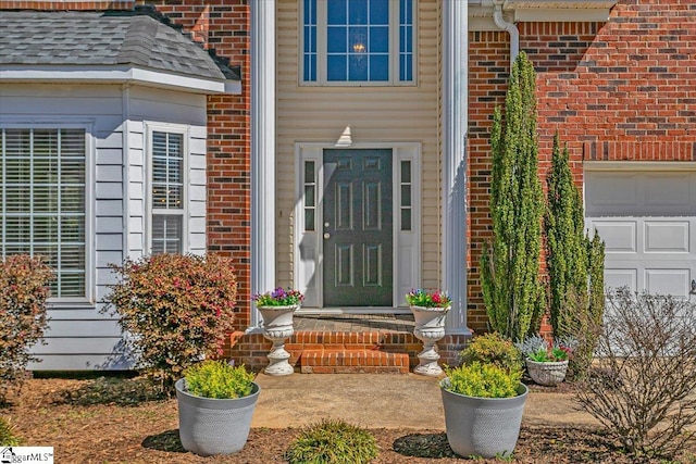 entrance to property featuring brick siding