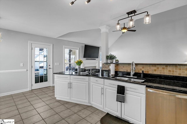 kitchen with a sink, white cabinets, dishwasher, ceiling fan, and vaulted ceiling