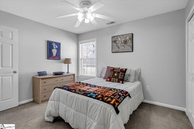 bedroom featuring ceiling fan, light colored carpet, visible vents, and baseboards