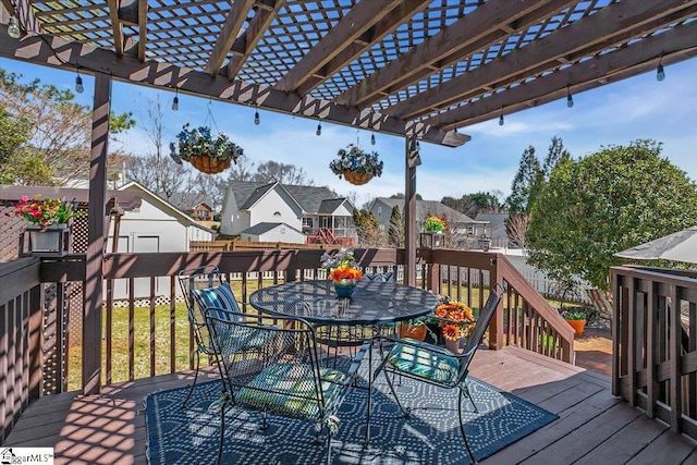 deck with outdoor dining space, a pergola, and a residential view