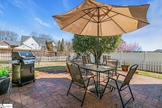 view of patio / terrace with outdoor dining space, a fenced backyard, and grilling area