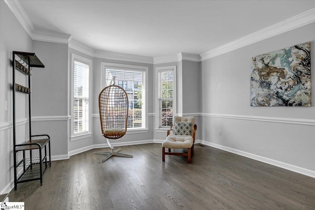 sitting room with visible vents, baseboards, wood finished floors, and crown molding