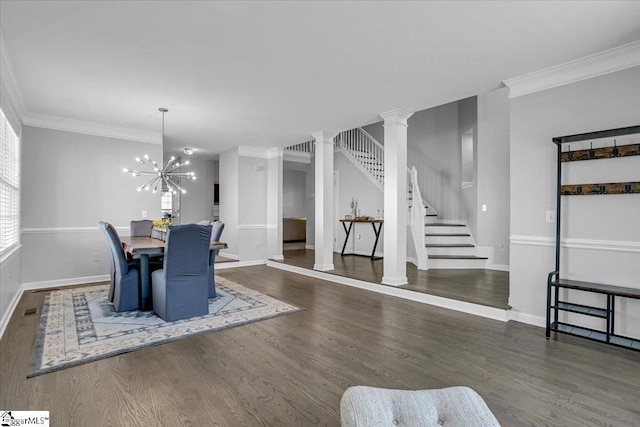 dining room featuring baseboards, stairs, ornamental molding, an inviting chandelier, and wood finished floors