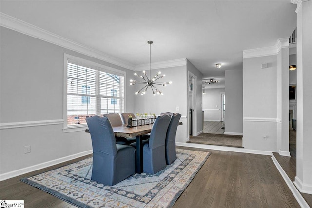 dining space featuring a chandelier, ornamental molding, and wood finished floors