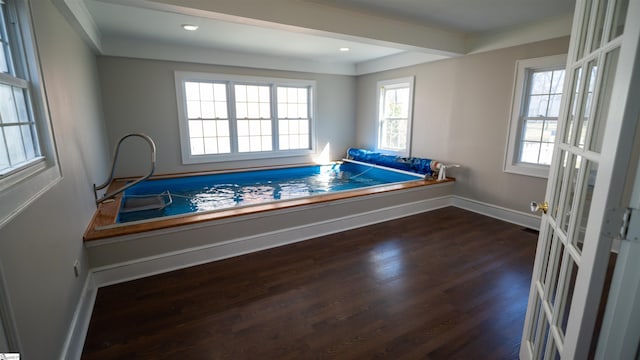 interior space with recessed lighting, wood finished floors, and baseboards