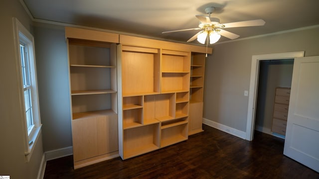 unfurnished bedroom featuring baseboards, dark wood finished floors, and crown molding