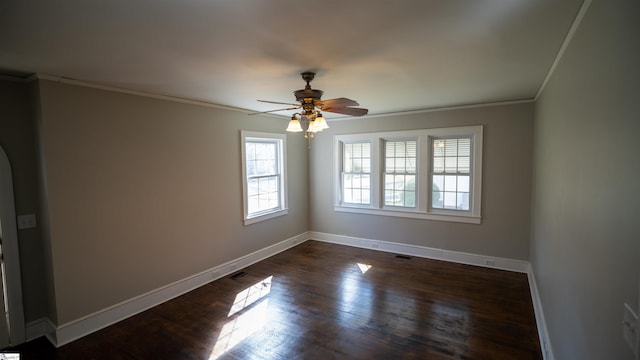 unfurnished room with dark wood-style floors, ceiling fan, crown molding, and baseboards