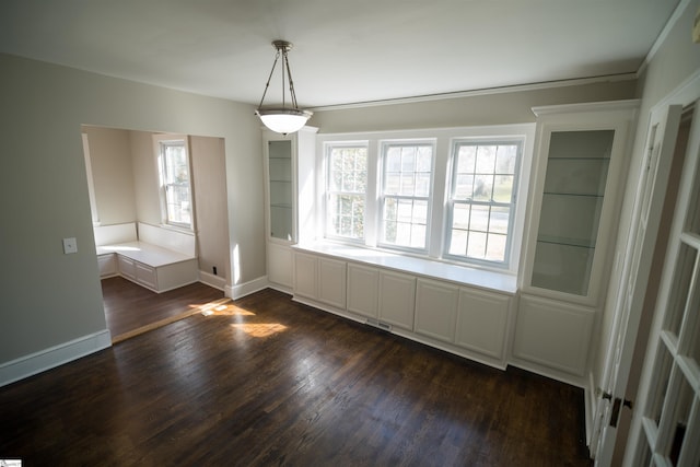 unfurnished dining area with visible vents, baseboards, and dark wood-style floors