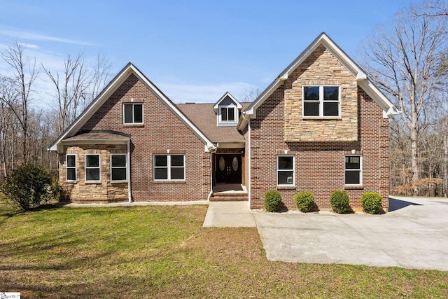 view of front of home with stone siding, brick siding, and a front lawn