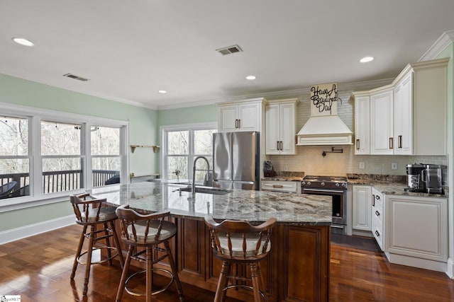 kitchen with visible vents, backsplash, appliances with stainless steel finishes, and dark wood finished floors