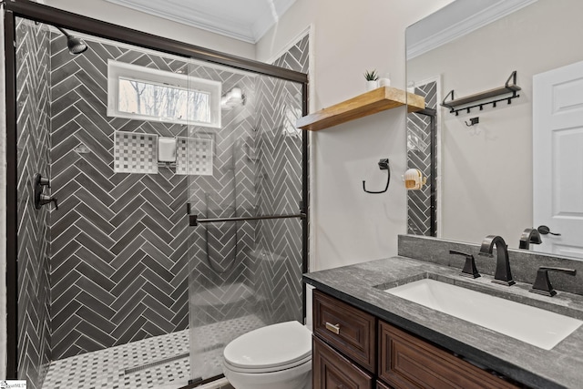 full bathroom featuring a stall shower, toilet, crown molding, and vanity