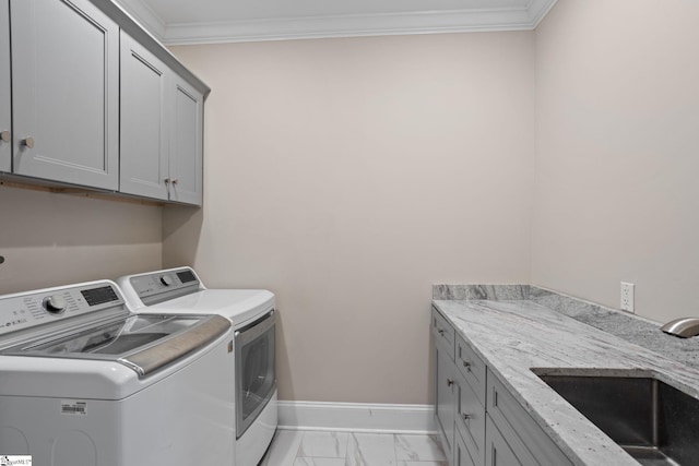 washroom with baseboards, cabinet space, a sink, washing machine and dryer, and marble finish floor