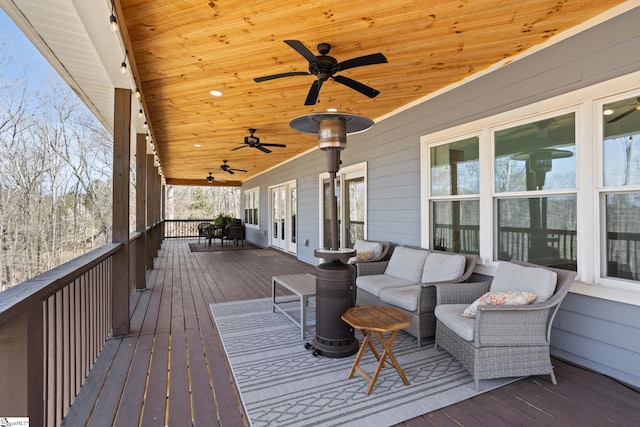 wooden terrace featuring a ceiling fan, french doors, and outdoor lounge area