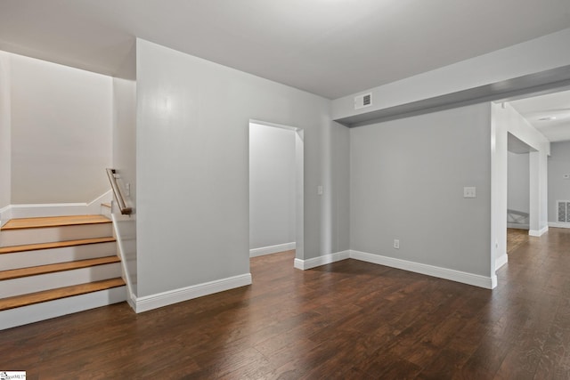 unfurnished living room with visible vents, baseboards, and hardwood / wood-style floors