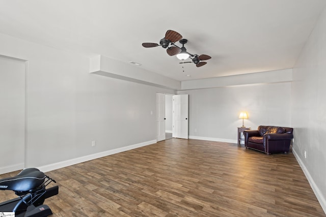 sitting room featuring baseboards, wood finished floors, and ceiling fan