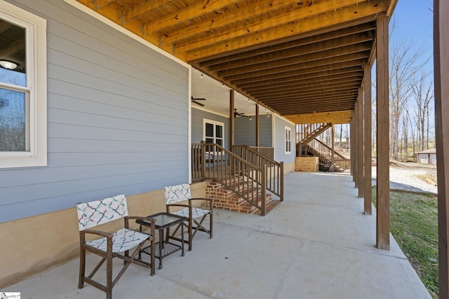 view of patio / terrace featuring stairway and a ceiling fan