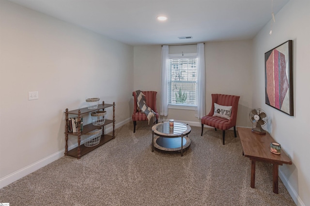 living area featuring carpet, visible vents, and baseboards